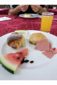 The last breakfast: Sweet bread, slice or watermelon, another piece of bread and mortadella. 